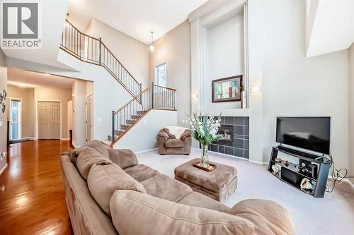 Open stairway with toms pf natural light - 11931 Valley Ridge Drive Nw, Calgary, AB - Indoor Photo Showing Living Room