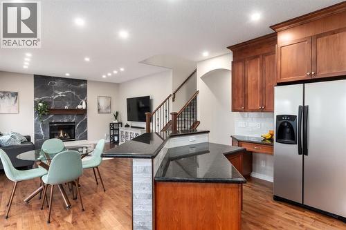 Granite countertops - 128 Seagreen Manor, Chestermere, AB - Indoor Photo Showing Other Room With Fireplace