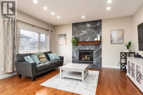 Floor to ceiling tile fireplace - 128 Seagreen Manor, Chestermere, AB - Indoor Photo Showing Living Room With Fireplace