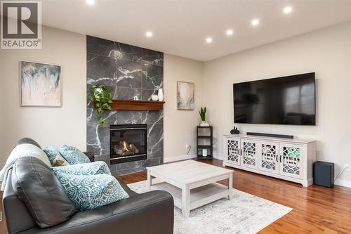 Recessed lighting - 128 Seagreen Manor, Chestermere, AB - Indoor Photo Showing Living Room With Fireplace