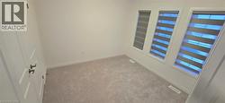 Carpeted empty room featuring baseboards - 