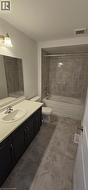 Bathroom with vanity and bathing tub / shower combination - 
