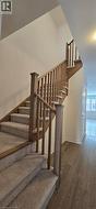Staircase with wood finished floors and baseboards - 