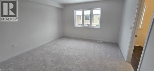 Empty room with light colored carpet and baseboards - 925 Douro Street, Stratford, ON - Indoor Photo Showing Other Room