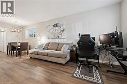 Home office featuring wood finished floors and a chandelier - 