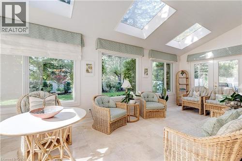Sunroom / solarium with lofted ceiling, a skylight, healthy amount of natural light, and tile patterned floors - 166 Maple Grove Drive, Oakville, ON - Indoor