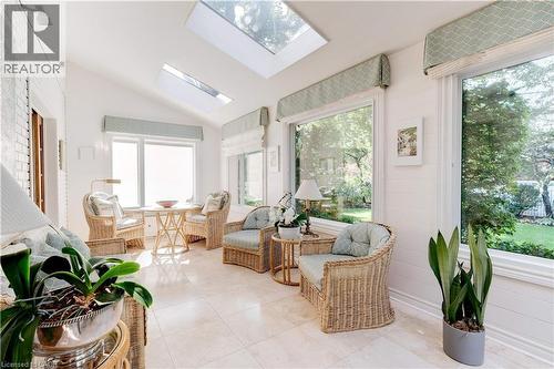 Sunroom / solarium featuring a skylight, vaulted ceiling, and tile patterned flooring - 166 Maple Grove Drive, Oakville, ON - Indoor