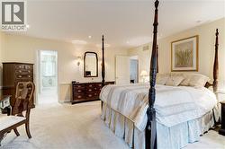 Bedroom with light carpet and recessed lighting - 