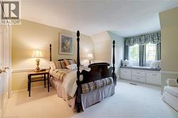 Bedroom featuring light colored carpet, a closet, and lofted ceiling - 