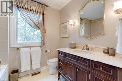 Bathroom with vanity, a shower with shower curtain, light tile patterned floors, and a bath - 