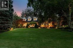 View of front of house featuring a front yard and a chimney - 