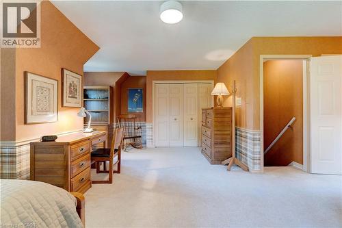 Bedroom featuring light carpet, a closet, an office area, and a wainscoted wall - 166 Maple Grove Drive, Oakville, ON - Indoor Photo Showing Bedroom