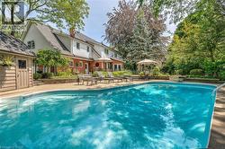 Outdoor pool featuring a patio and an outdoor structure - 