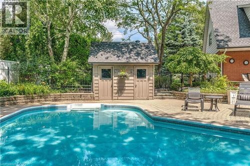 View of swimming pool featuring a patio and an outdoor structure - 166 Maple Grove Drive, Oakville, ON - Outdoor With In Ground Pool