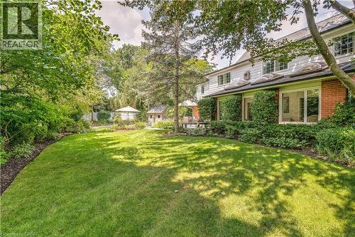 View of grassy yard featuring view of wooded area - 166 Maple Grove Drive, Oakville, ON - Outdoor