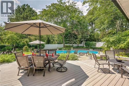 Deck featuring outdoor dining space, a fenced backyard, and view of scattered trees - 166 Maple Grove Drive, Oakville, ON - Outdoor With Deck Patio Veranda