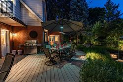 Deck featuring outdoor dining space and an outdoor kitchen - 