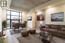 Building lobby featuring expansive windows and recessed lighting - 24 Augusta Street Unit# 305, Hamilton, ON  - Indoor Photo Showing Living Room 