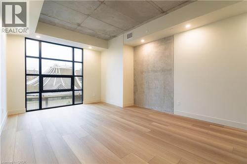 Empty room with light wood-style flooring, recessed lighting, and floor to ceiling windows - 24 Augusta Street Unit# 305, Hamilton, ON - Indoor Photo Showing Other Room