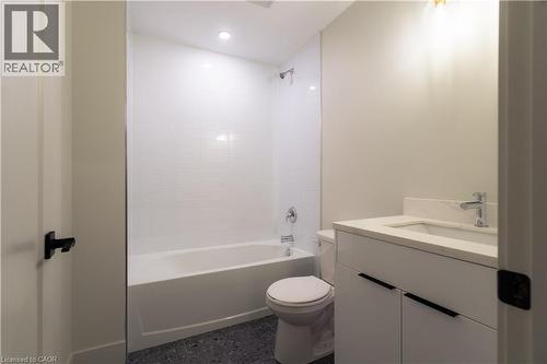 Bathroom with vanity and bathtub / shower combination - 24 Augusta Street Unit# 305, Hamilton, ON - Indoor Photo Showing Bathroom