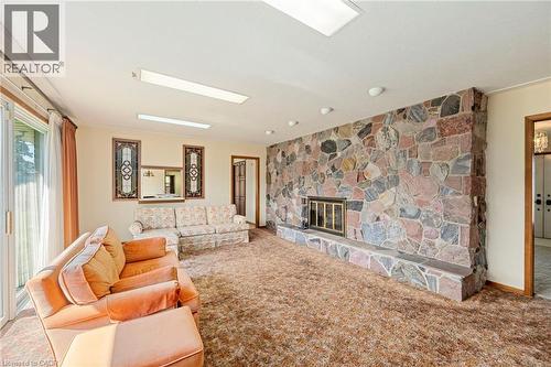 Living room featuring carpet and a fireplace - 6828 Third Line, Chatham, ON 