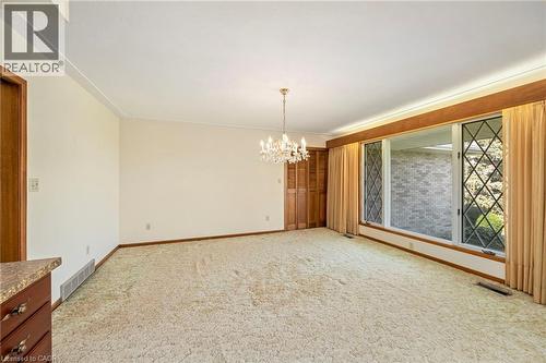 Spare room featuring a chandelier and light carpet - 6828 Third Line, Chatham, ON 