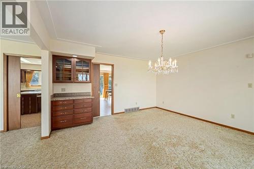 Spare room with light colored carpet and a chandelier - 6828 Third Line, Chatham, ON 