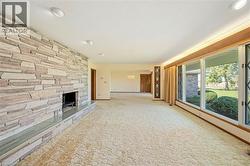 Unfurnished living room with a chandelier and carpet floors - 