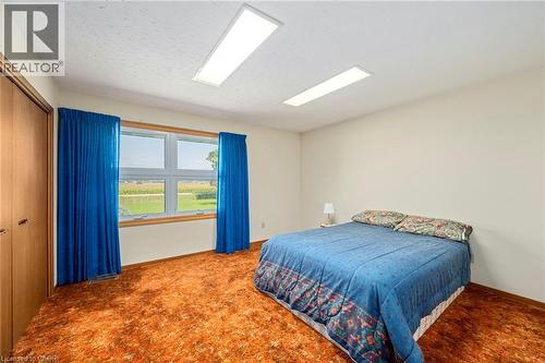 Bedroom with carpet flooring, a closet, and a textured ceiling - 6828 Third Line, Chatham, ON - Indoor Photo Showing Bedroom