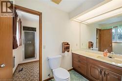 Bathroom featuring a stall shower and vanity - 