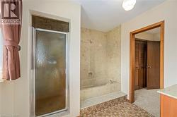 Full bath featuring a marble finish shower, vanity, and a bath - 
