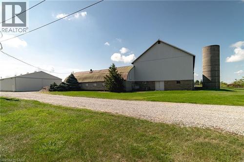 View of property exterior featuring a yard, an outdoor structure, a pole building, and gravel driveway - 6828 Third Line, Chatham, ON - Outdoor