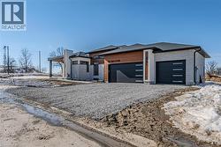 View of front of home with an attached 3 car garage - 