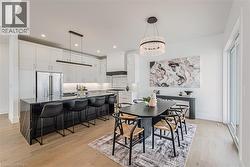 Open Concept Kitchen & Dinette featuring an Island and Sliding Doors to a covered Deck - 