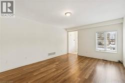 Empty room with wood finished floors and baseboards - 