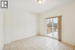 Unfurnished room featuring baseboards and light tile patterned floors - 