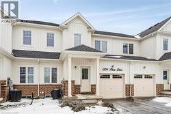 Modern farmhouse featuring a garage, driveway, a shingled roof, and board and batten siding - 