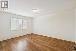 Spare room featuring hardwood / wood-style floors and baseboards - 