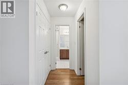 Corridor featuring light wood-style flooring - 