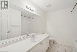 Full bathroom with vanity, light tile patterned flooring, and bathing tub / shower combination - 