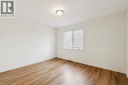 Empty room featuring light wood-style floors and baseboards - 