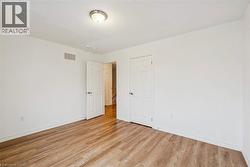 Empty room with light wood-style flooring and baseboards - 