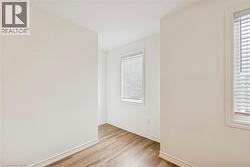 Empty room with light wood-style floors and baseboards - 