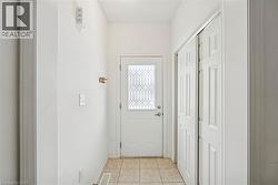 Doorway to outside with tile patterned floors - 