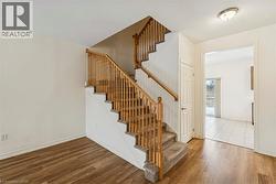 Stairway featuring wood finished floors and baseboards - 