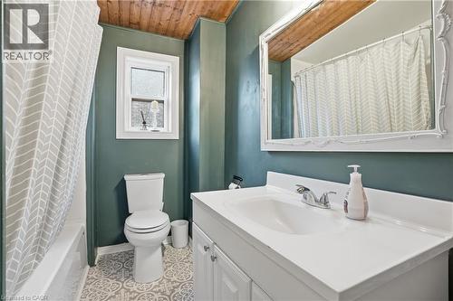 Full bath featuring vanity, shower / tub combo, wooden ceiling, and light tile patterned flooring - 313 Mary Street, Hamilton, ON - Indoor Photo Showing Bathroom