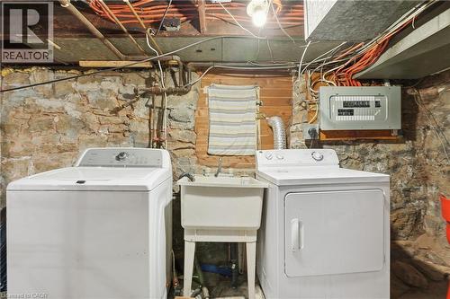 Laundry area with electric panel and washing machine and dryer - 313 Mary Street, Hamilton, ON - Indoor Photo Showing Laundry Room