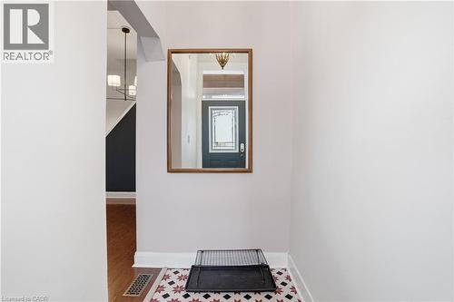 Hallway with baseboards and wood finished floors - 313 Mary Street, Hamilton, ON - Indoor Photo Showing Other Room
