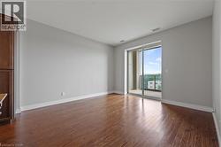 Spare room with baseboards and dark wood-style floors - 