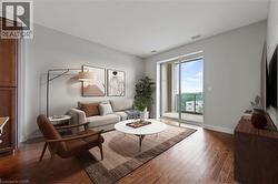 Living area with hardwood / wood-style floors and baseboards - 